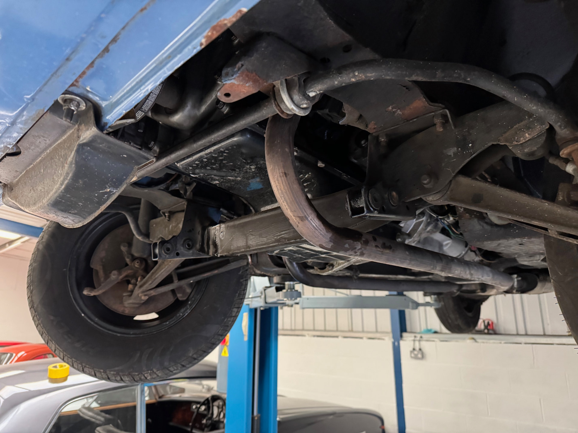 The underside of the Stag before stripping, with surface corrosion visible on the suspension and structural components.