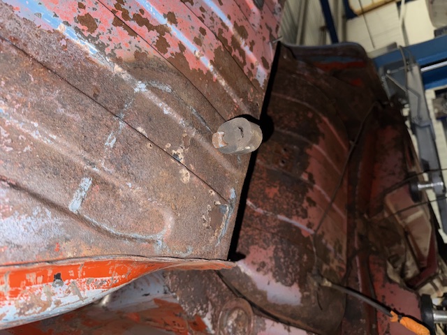 The underside of the Stag stripped back to bare metal, with surface corrosion still visible.