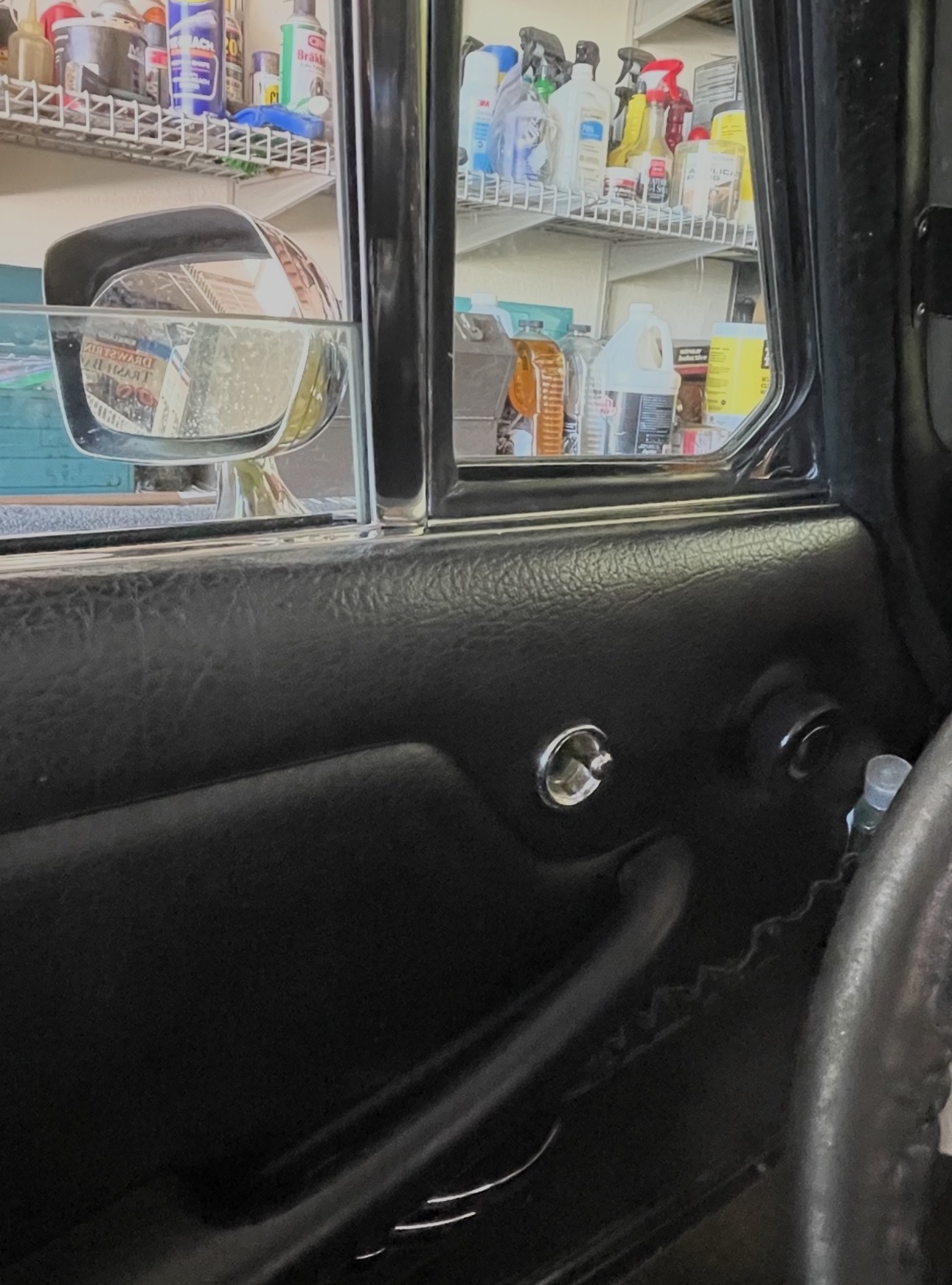 The Federal door mirror seen from the driver's seat, with the interior adjustment control on the door.