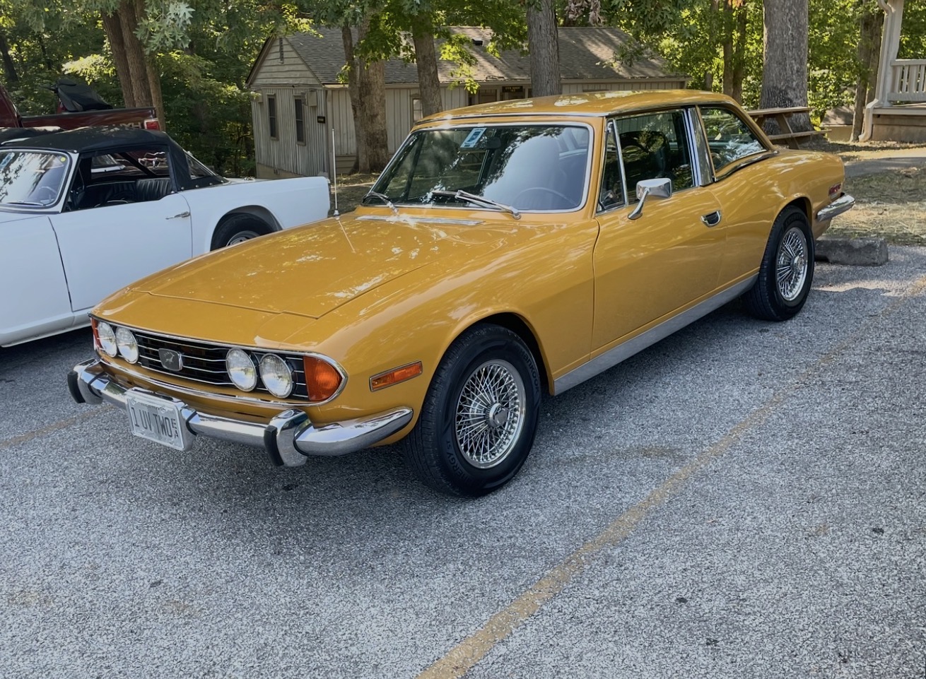 A Federal-specification Triumph Stag with the hardtop fitted, parked at a club meeting in the United States.