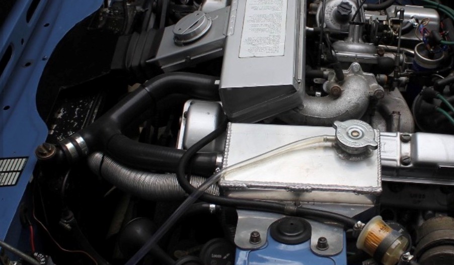 Owner-uploaded Triumph Stag engine bay showing the header tank, radiator and coolant hoses