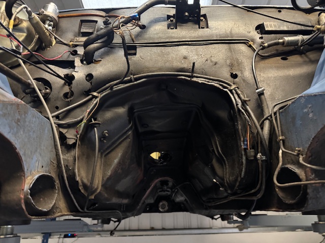 The Stag gearbox tunnel with wiring and fixtures exposed during strip-down.